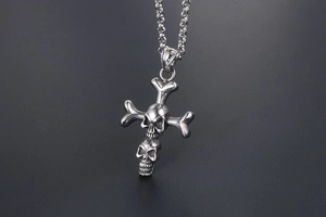 Detailed view of silver punk double skull cross pendant in polished titanium steel