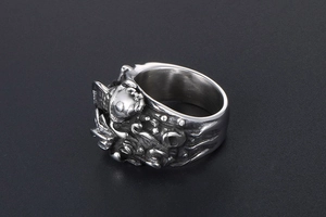 Macro shot of retro stainless steel ring with 3D embossed koi fish wave relief