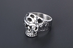Detailed close-up of a silver punk skull ring made of vintage titanium stainless steel
