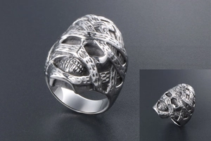 Macro view of gothic mummy skull ring featuring vintage stainless steel woven textures