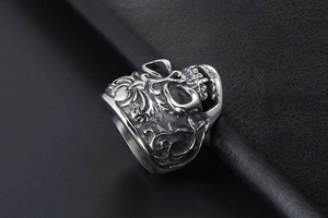 Macro view of stainless steel skull ring with vintage floral gothic relief details