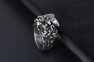 Macro detail of retro fish and wave relief on titanium steel ring with black finish