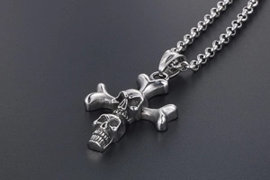 Close-up of double skull and crossbones pendant necklace in punk style vintage steel