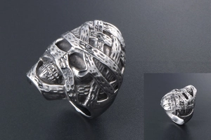 Macro view of wide vintage stainless steel ring with intricate gothic textured relief