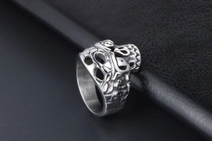 Detailed relief of punk skull and bone patterns on a polished steel biker ring