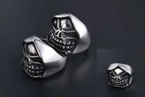 Macro view of vintage punk skull ring featuring detailed gothic hood and polished finish
