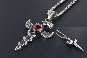 Detail of gothic sword pendant with red heart gemstone and snake wrap design
