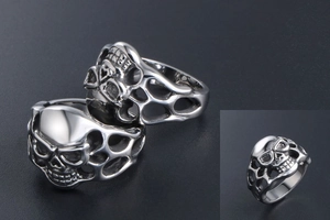 Macro detail of gothic skull ring with intricate hollow flame patterns and silver finish