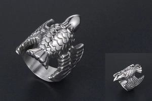 Macro shot of vintage titanium steel flying eagle ring showing intricate feather texture