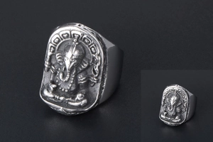 Macro shot of vintage titanium steel ring featuring detailed Ganesha elephant relief carvings