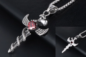 Close-up of gothic sword pendant with winged snake and red heart zircon stone