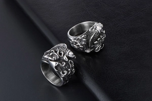 Macro detail of vintage titanium steel ring with koi fish and wave relief textures