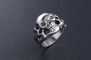 Detailed top view of vintage gothic skull ring with hollow honeycomb steel design