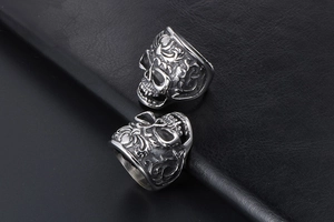 Detailed view of vintage gothic skull ring with intricate floral embossed steel carvings
