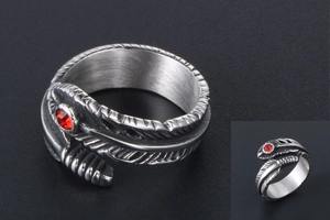 Macro detail of vintage feather ring in silver steel with a bright red rhinestone