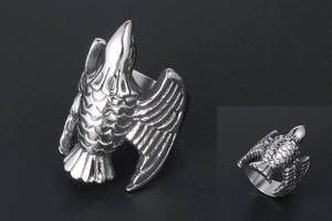 Macro detail of vintage steel eagle ring showing intricate feather textures and carvings