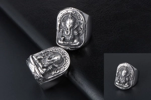 Macro view of vintage titanium steel ring featuring detailed Ganesha deity relief engraving