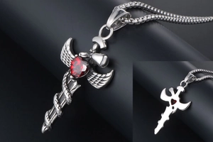 Macro detail of gothic sword and angel wing pendant with a red heart gemstone and box chain