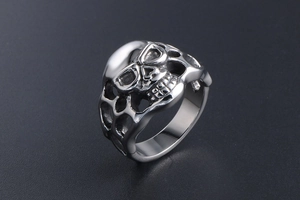 Detailed macro view of Gothic skull ring with intricate hollow side patterns in steel