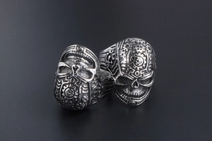 Detailed view of vintage steampunk skull rings with intricate gear and industrial textures