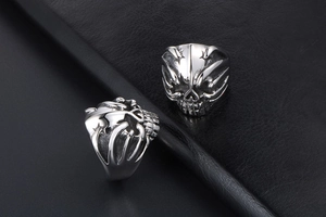 Detailed macro view of vintage gothic skull rings with aged stainless steel textures