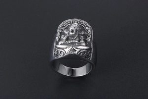 Macro shot of vintage silver Ganesha relief on a wide titanium steel ring for men