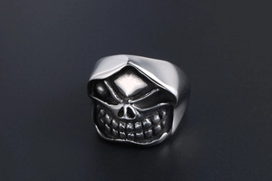 Close-up of gothic skull ring with hooded design in vintage matte silver finish