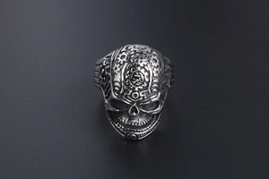 Close-up of vintage skull ring with intricate gear mechanical details on forehead