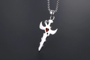 Detail of angel sword pendant in titanium steel featuring a red heart gemstone inlay