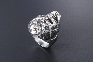 Macro view of vintage hammered texture on blackened steel punk style mummy ring