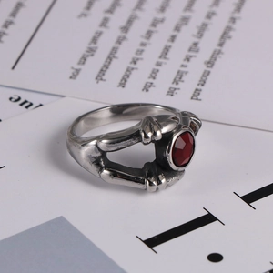 Gothic vintage stainless steel ring featuring red gemstone and intricate bone claw design