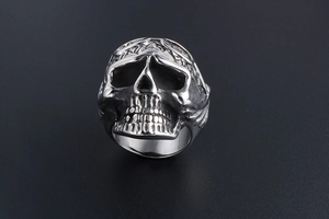 Macro shot of punk vintage skull ring with detailed oxidized finish and stainless steel texture