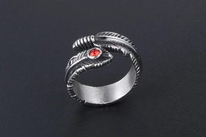 Close-up of vintage feather ring in silver steel with a bright red synthetic gemstone