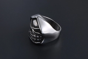 Macro shot of punk style skull ring showing 3D embossed gothic details on stainless steel