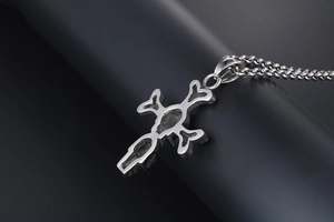 Macro detail of gothic S925 sterling silver skull cross pendant with fine link chain
