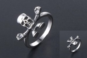Macro shot of punk style stainless steel skull ring with vintage gothic bone details