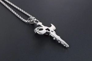 Close-up of sword key pendant with red heart zircon on a stainless steel box chain