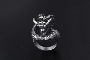 Detailed view of vintage silver dragon head ring with intricate scale texture and scales