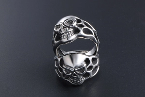 Macro shot of vintage gothic skull rings with hollow-out punk style and silver finish