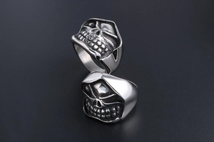 Macro detail of gothic skull rings in polished stainless steel with vintage oxidation