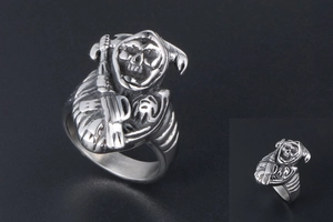 Detailed close-up of a punk style stainless steel skull ring with gothic reaper design