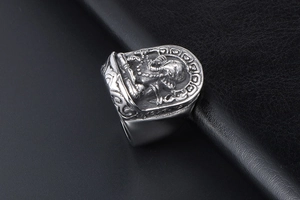 Detailed macro view of retro Ganesha relief carving on a silver titanium steel ring