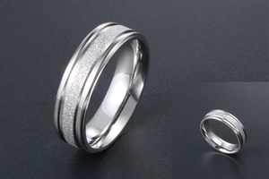 Close-up of titanium steel ring with polished edges and a sparkling frosted center inlay