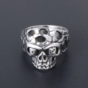 Silver stainless steel skull ring with dice eye details in punk industrial style