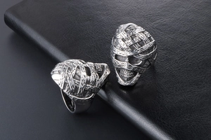 Detailed close-up of a silver mummy skull ring with gothic punk bandage texture and finish