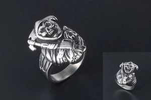 Detailed close-up of punk style skull ring with vintage silver finish and reaper relief