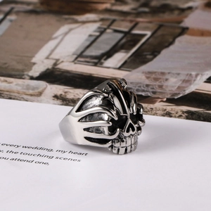 Gothic punk skull ring in vintage silver titanium steel for men on artistic background