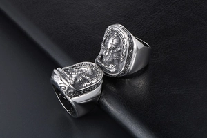 Detailed macro view of vintage silver Ganesha relief on wide stainless steel ring band