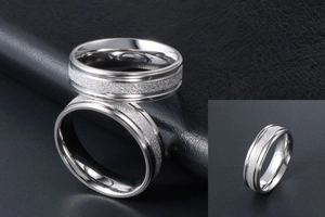 Detail of silver titanium ring with frosted glitter inlay and polished grooved edges