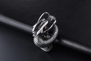 Macro detail of vintage silver dragon ring with intricate scales and punk style carving